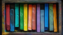 A Set Of Colorful Chalk Sticks Arranged In A Box, Ready For Artistic Expression On A Chalkboard.