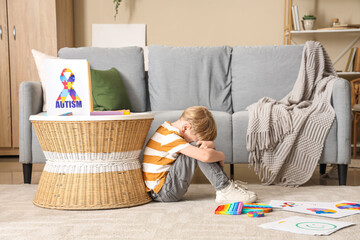 Poster - Stressed little boy sitting on floor at psychologist's office. World Autism Awareness Day