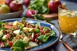 Apple walnut salad similar to Waldorf on blue plate with orange juice