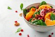 Close up image of a vibrant fruit salad in a bowl on a white background Includes oranges pomegranate spinach and nuts Space for text Healthy vegetar