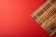 Empty wooden table with bamboo place mat over red background. Chinese New Year mock up for design and product display - generative ai 