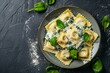 Ravioli with parmesan, basil, and olive oil on a dark background.