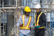 © eakgrungenerd - Construction civil engineer man and woman African American checking quality of work in construction site. Team of various nationalities working inspecting infrastructure building progress.