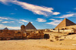 Spectacular view of the all 3 Great Pyramids of Khufu,Khafre and Menkaure along with the enigmatic Great Sphinx with background of brilliant blue skies on the Giza plateau at Cairo,Egypt