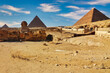 Magnificent scene of the the historic sights of Egypt -  3 Great Pyramids of Khufu,Khafre and Menkaure along with the Great Sphinx against bright blue skies on the Giza plateau at Cairo,Egypt