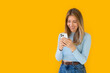 © kostikovanata - Caucasian businesswoman in formal attire in her office happy and cheerful while using smartphones