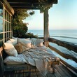Cozy seaside deck with a blanket-covered bench and ocean view