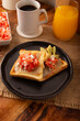 Avocado toast with refried beans, avocado, melted cheese and mexican pico de gallo sauce. Easy and healthy homemade recipe that can be made in the oven, frying pan or air fryer.