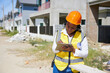 worker or architect working on tablet for home inspection at construction site