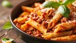 Pasta penne with tomato bolognese sauce parmesan cheese and basil leaves