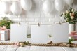 Blank White Cards Hanging on Rope with Festive Party in the Background