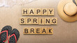 Slipper with beach hat and wooden cubes with Happy Spring Break text