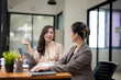 © Wasana - Smiling businesswoman listens attentively during a productive team meeting in a contemporary office setting.