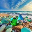 Colorful gemstones on a beach. Polish textured sea glass and stones on the seashore. Green, blue shiny glass with multi-colored sea pebbles close-up autumn, blue, spring, painting, flowers, trees, sea