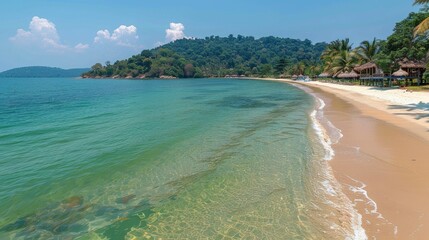 The beach is beautiful, with white sand and clear water. There are a few trees on the beach, and the water is calm.