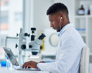 Poster - Scientist, man and laptop in lab with research for medical study, microscopic experiment or DNA testing with earphones. Science, african expert and serious for gene editing or healthcare breakthrough