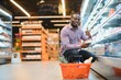 Attractive african american man shopping in a supermarket