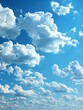 Light, airy clouds float in vast blue sky, creating tranquil, heavenly clear summer atmosphere with peaceful floating clouds