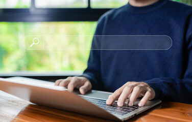 Wall Mural - man using a laptop shows a search bar. concept of web browser information, keyword search engines, s