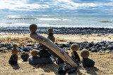 Fototapeta Miasto - Pretty pile of wooden pebbles and balls of sand facing the sea