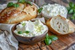 Homemade farm bread with cottage cheese and green herbs served in a bowl on a wooden table