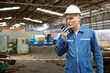 technician or engineer talking on walkie talkie in the factory