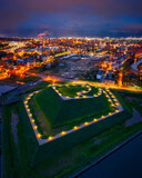 Fototapeta Konie - Bison bastion, 17th-century fortifications of Gdańsk illuminated at night. Poland
