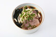 Beef and noodles soup in Asian style. Pho Bo soup. Sea cabbage with green onions in broth. Copy space. Isolated object.