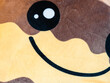 Close-Up of a Plush Toy with a Smiley Face.