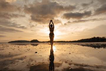 Wall Mural - summer travel,Woman walking on the beach in the evening