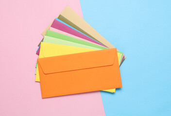 Wall Mural - Set of colored envelopes on a blue-pink pastel background