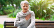 © peopleimages.com - Senior woman, heart attack and pain in park, pneumonia and cardiac risk or hypertension in nature. Female person, heartburn and stress on lungs or bench, stroke and danger of healthcare or disease