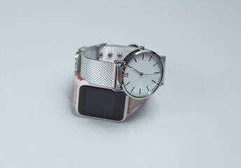 Wall Mural - Modern smart and analog watches on gray background.