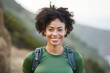 © Markus Schröder - Portrait of a grinning afro-american woman in her 40s sporting a breathable hiking shirt in rocky cliff background