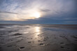 Sun reflection on the water on the beach at St. Peter Ording, North Sea, Germany, during sunset, horizontal shot