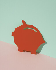 Wall Mural - Red Paper-cut Piggy bank on blue-pink pastel background. Creative layout