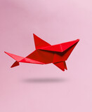 Fototapeta Mapy - Red Origami shark levitating on pink