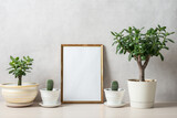 Fototapeta Natura - Template with photo frame on a wooden table. Houseplants in a pots.