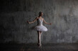 Slender and beautiful ballerina performing the role of the White Swan.