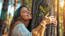 Portrait Of A Woman Hugging A Tree In The Forest Smiling And Being Happy 