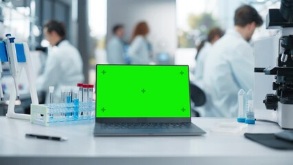 Aufkleber - Laptop Computer with Green Screen Chromakey Template Standing on a Desk in a Science Laboratory Next to a Microscope and Test Tubes with Genomics Samples. Scientists Working in the Background