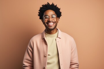 Wall Mural - Portrait of a jovial afro-american man in his 20s wearing a chic cardigan in pastel or soft colors background