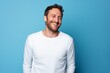 © Markus Schröder - Portrait of a cheerful man in his 30s sporting a long-sleeved thermal undershirt on solid color backdrop