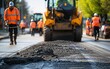 © Digital Dreamscape - A construction worker and machinery are captured mid-operation in a street rehabilitation project, with the team in action in the background. Keywords:
