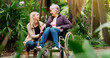 © peopleimages.com - Smile, woman and senior mother in wheelchair at park for conversation, retirement and help for support. Daughter, mom and person with a disability in garden for love, laugh and happy family bonding