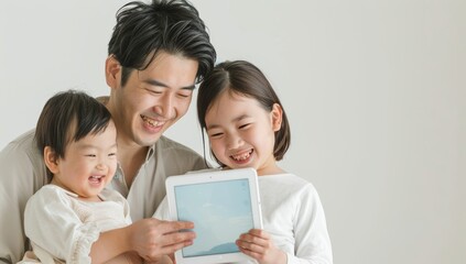 A Japanese family of three is smiling and looking at an iPad or tablet. Young child online learning and entertainment. Portrait of happy asian family spending time together family and home concept