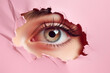 Woman;s eye peeping through a hole in pink torn paper. Psychology mental health stress concept. Banner template for sale