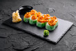 Spicy tuna sushi rolls on slate plate