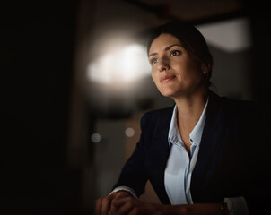 Poster - Night, email and woman in office with computer for research, website review or networking. Reading, internet search and businesswoman at desk with online report, article or thinking in dark workplace