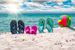 Flip-flops, beach voleyball ball on the sand. Beach summer holiday concept
